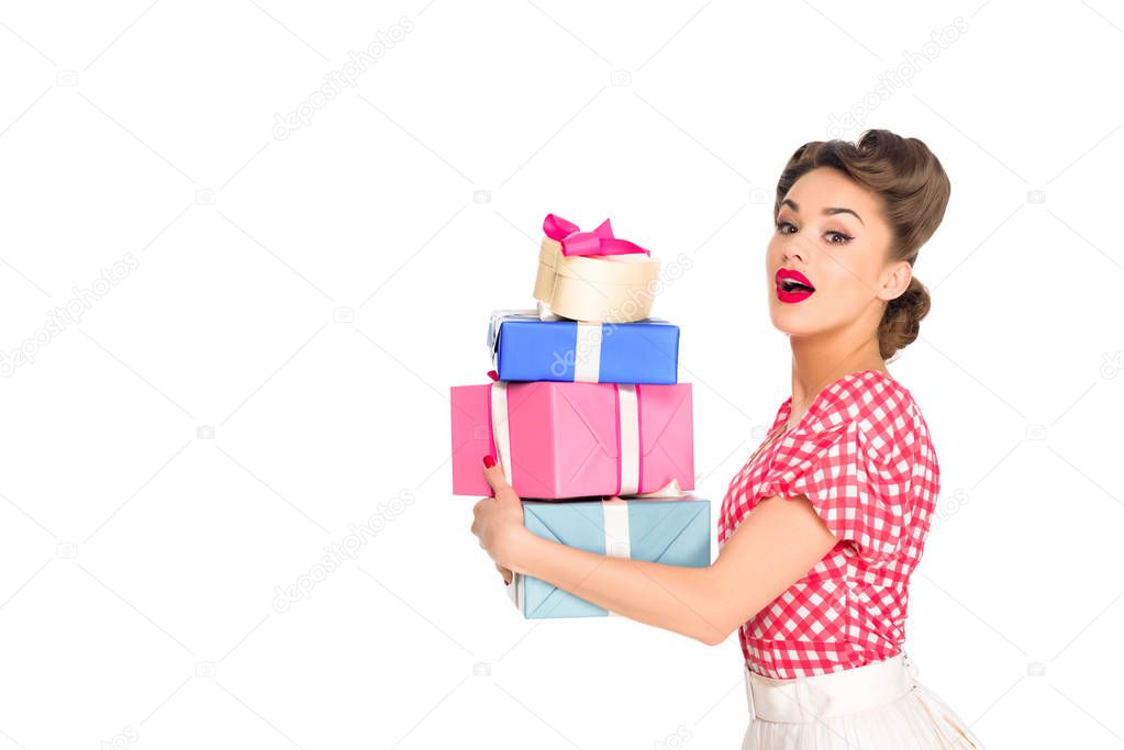 side view of beautiful woman in retro clothing holding wrapped presents isolated on white