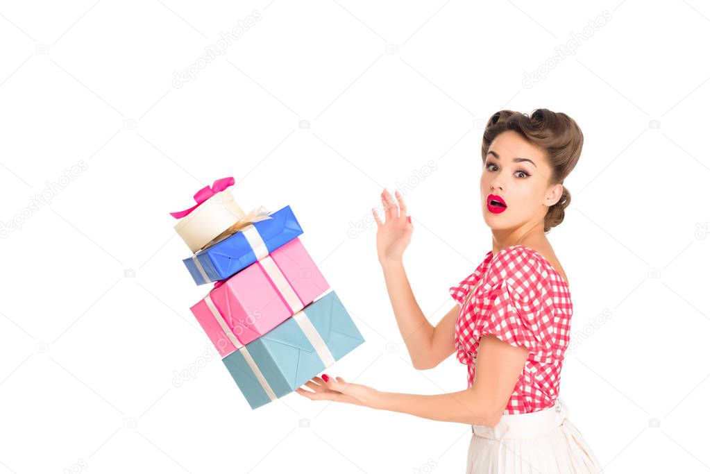 side view of beautiful woman in retro clothing holding falling wrapped presents isolated on white