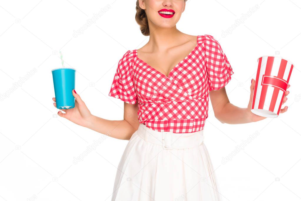 partial view of woman in retro style clothing with pop corn and drink in hands isolated on white