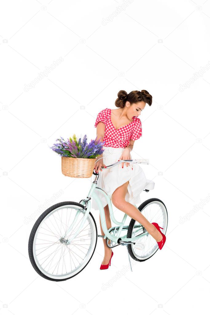 attractive pin up woman on retro bicycle isolated on white