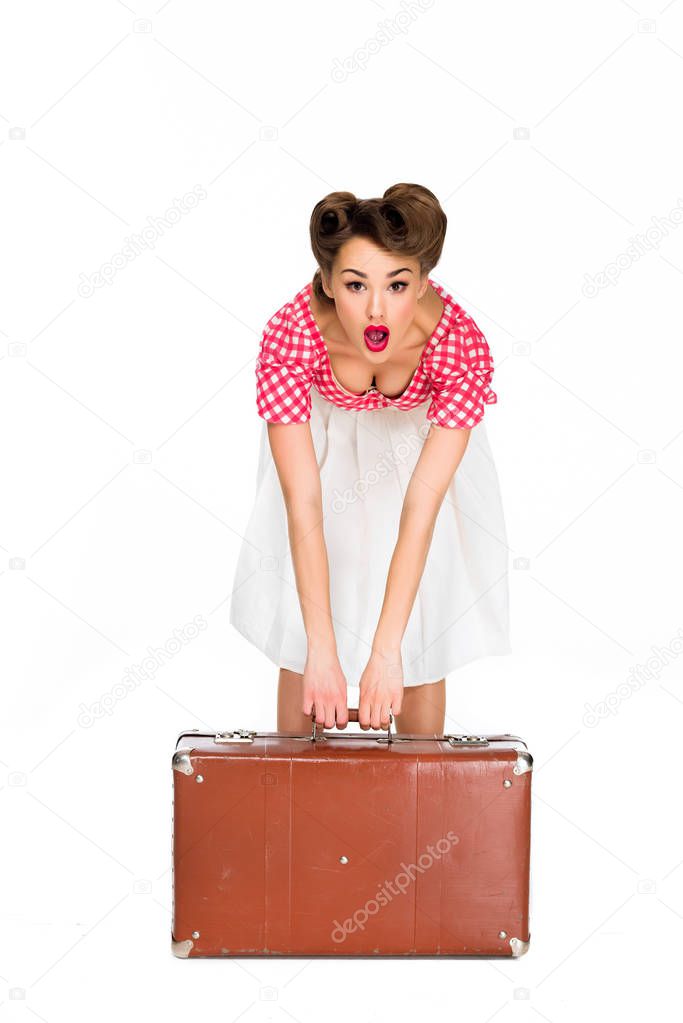 emotional beautiful young woman in retro clothing holding suitcase isolated on white
