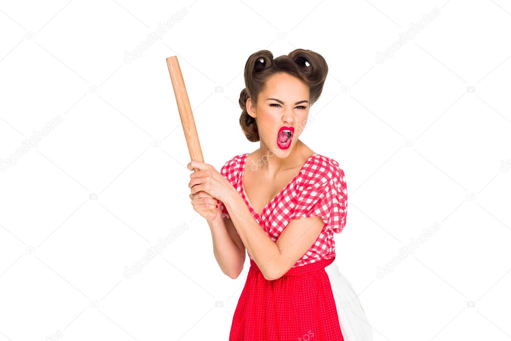 angry stylish woman in retro clothing and apron with rolling pin isolated on white