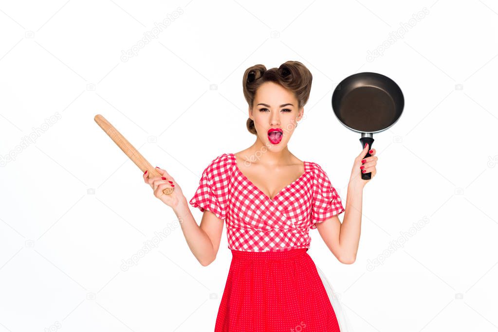 stylish woman in retro clothing with rolling pin and frying pan isolated on white