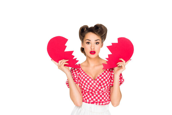 portrait of beautiful young woman in retro clothing with ripped paper heart isolated on white