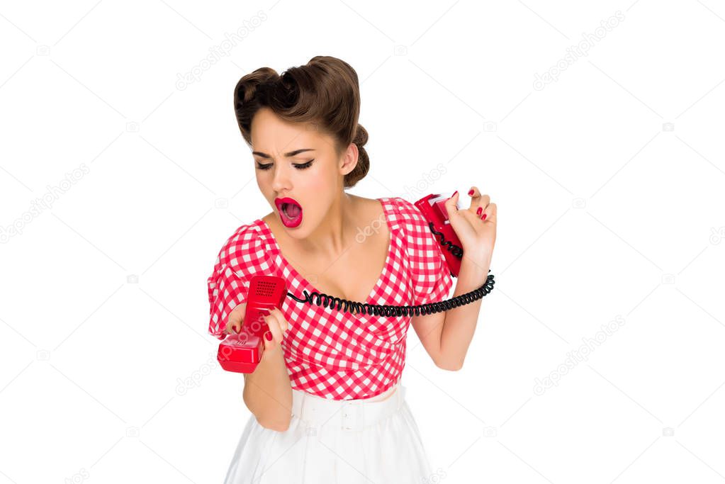 pin up woman screaming into old telephone tube isolated on white