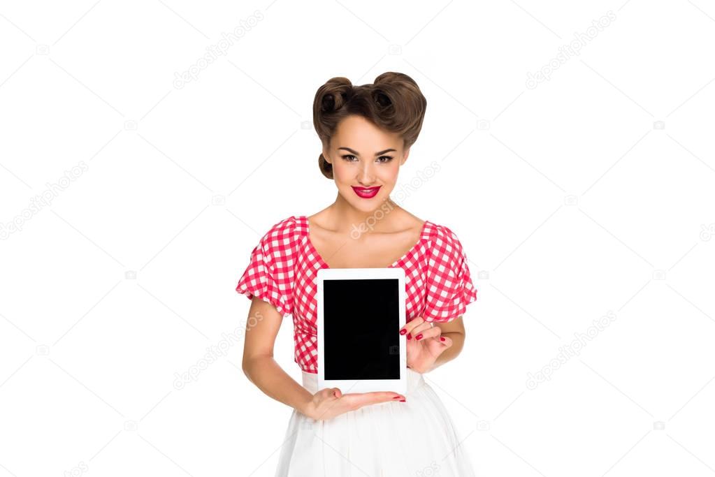 portrait of smiling woman in pin up style clothing showing tablet isolated on white