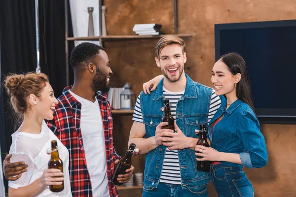 Felices Jóvenes Amigos Multiétnicos Sosteniendo Botellas Cerveza Hablando Juntos — Foto de stock gratis