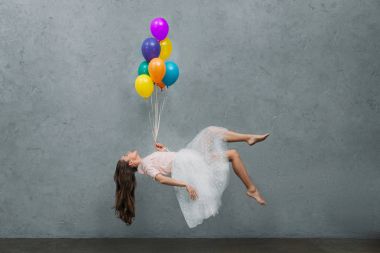 young woman levitating with colorful balloons clipart