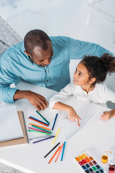 Overhead View African American Daughter Pointing Paint Showing Father — Stock Photo, Image