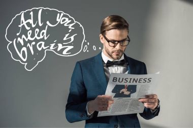 portrait of handsome stylish businessman in spectacles reading newspaper and all you need is brain inscription on grey clipart