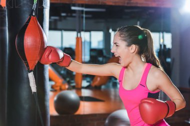active sporty woman doing boxing training at gym clipart
