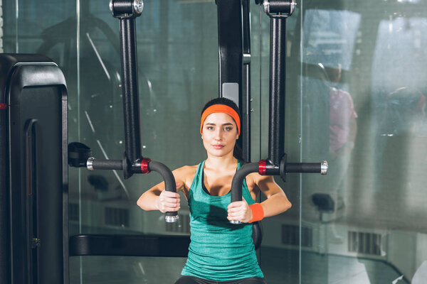 sporty woman working out on training apparatus at gym