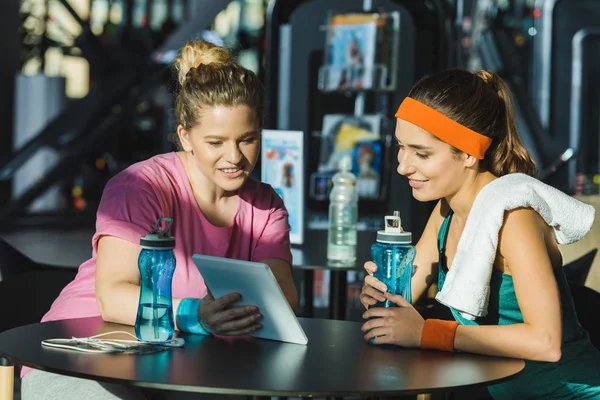 Frauen Sitzen Tisch Und Schauen Fitnessstudio Auf Digitale Tablets — Stockfoto