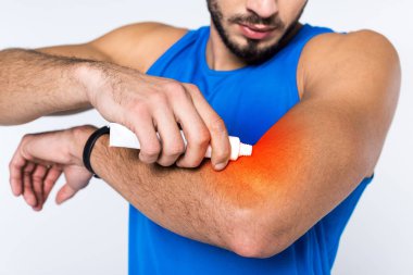 cropped shot of man applying ointment on arm while having arm pain clipart