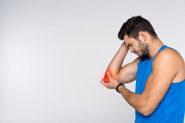 side view of young man with elbow pain isolated on white