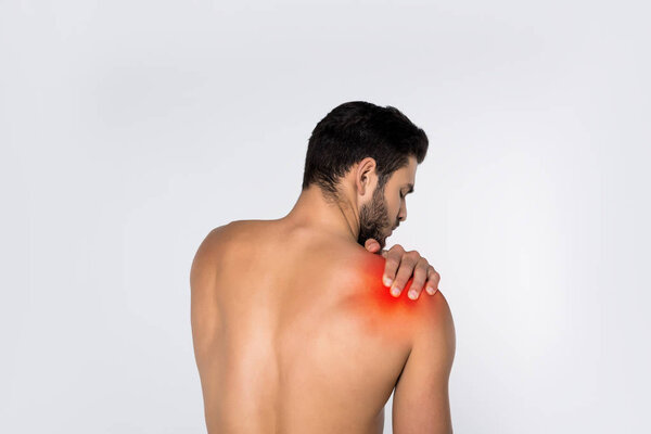 back view of young shirtless man with pain in shoulder isolated on white