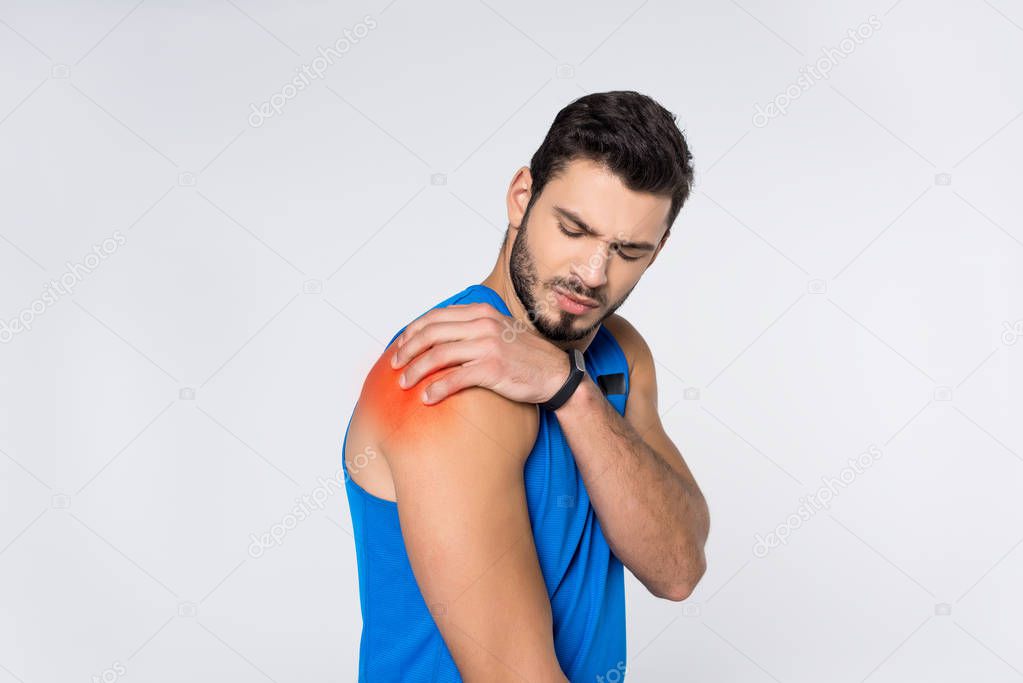 young man with pain in shoulder isolated on white