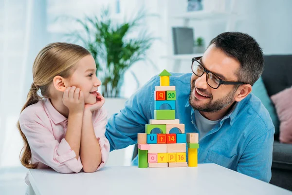 Portrait Family Looking Each Other Pyramid Colorful Blocks Home — Stock Photo, Image