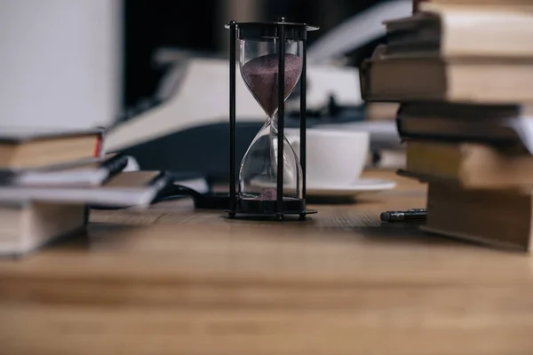 砂時計と積み重ねられた本のクローズ アップ ショット — ストック写真