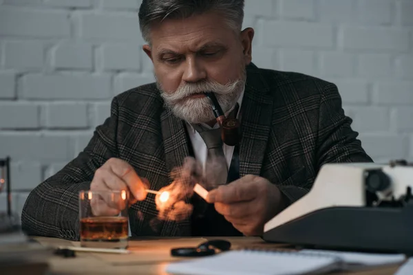 Bearded Senior Writer Burning Match Smoking Pipe Workplace — Stock Photo, Image