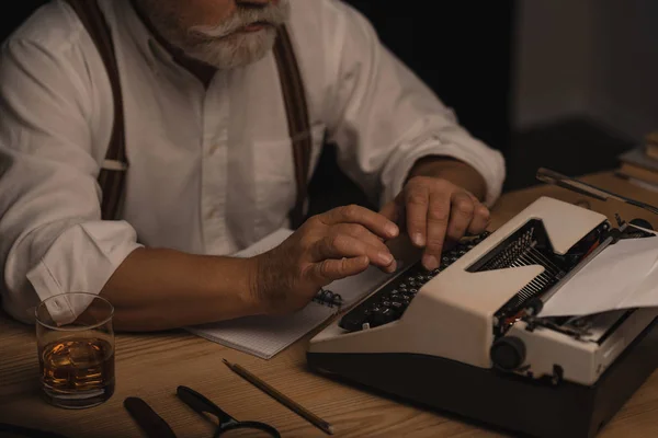 Bijgesneden Schot Voor Senior Schrijver Werken Met Typemachine Geïsoleerd Zwart — Stockfoto