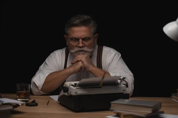 Thoughtful Senior Writer Sitting Workplace Isolated Black — Stock Photo, Image