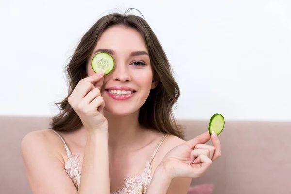 Schöne Junge Frau Pyjama Hält Gurkenscheiben Der Hand Und Lächelt — Stockfoto