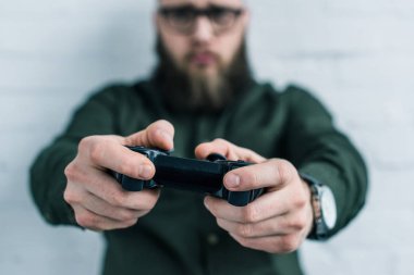 selective focus of businessman with gamepad in hands clipart