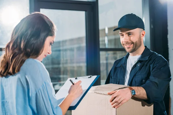 Woman Sighing Cargo Declaration While Courier Holding Box — Stock Photo, Image