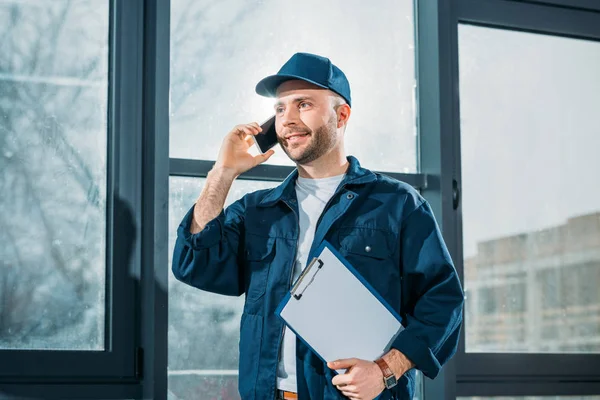 Courier Holding Urklipp Och Ringa Ett Samtal — Stockfoto