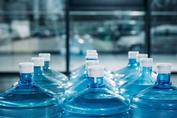 Rows of large blue water bottles