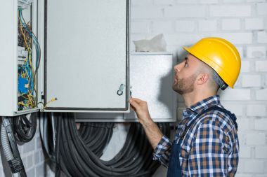 Electrician checking wires of power line maintenance clipart