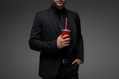 Cropped view of businessman with disposable cup isolated on grey clipart