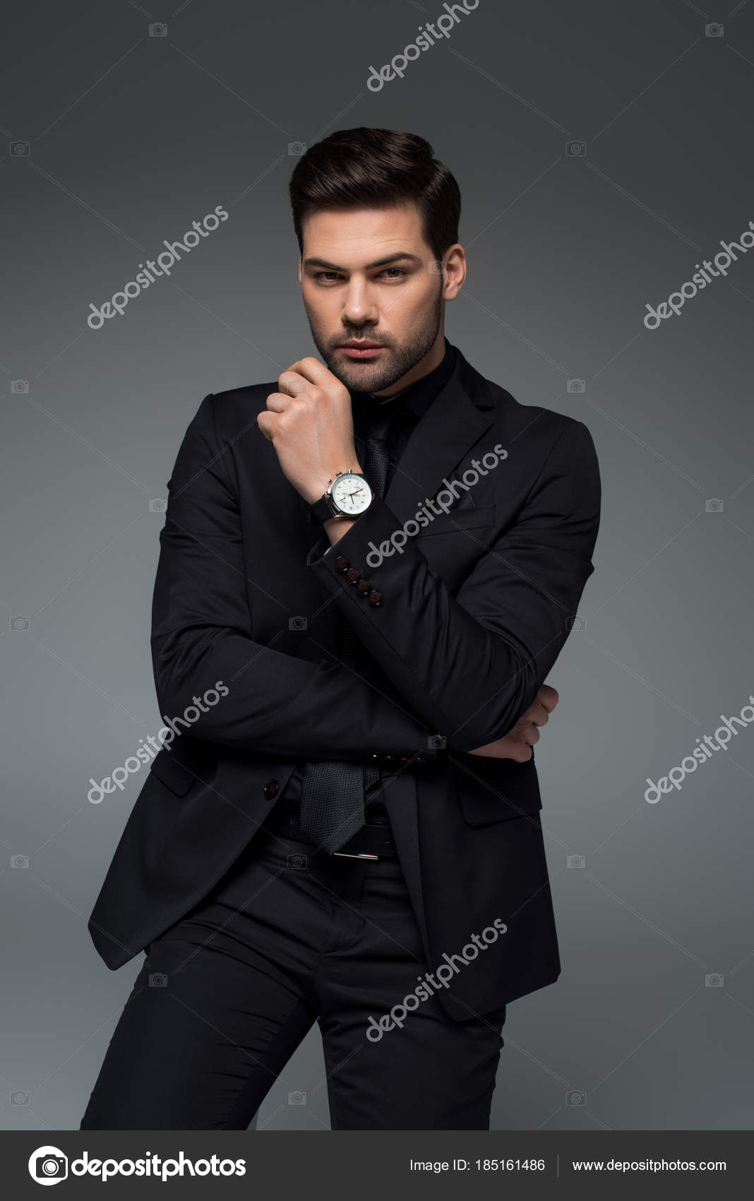 A Businessman in Black Suit Posing while Holding a Walking Stick · Free  Stock Photo