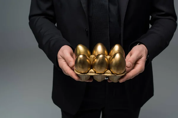 Erkek Üzerinde Izole Gri Paskalya Kavramı Elinde Altın Yumurta Closeup — Stok fotoğraf