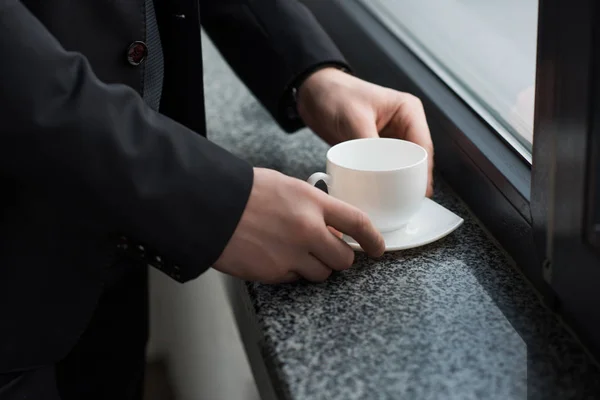 Partial View Businessman Holding Cup Coffee Window Sill — Stock Photo, Image