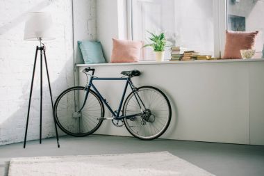 bicycle near windowsill in living room clipart