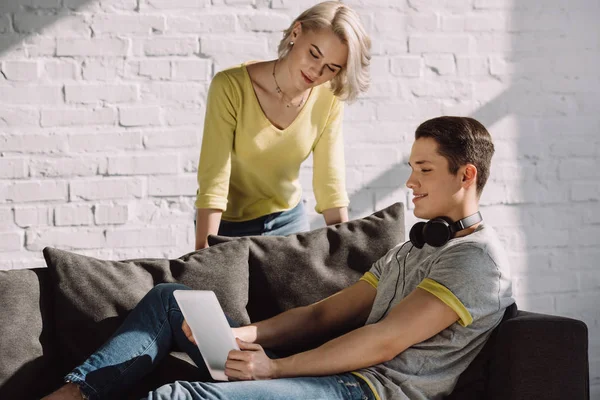 couple looking at tablet in living room