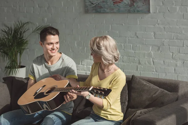 Smiling Boyfriend Giving Acoustic Guitar Girlfriend Home — Stock Photo, Image