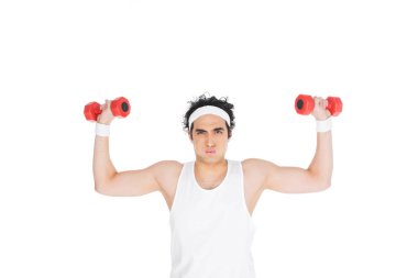 Young skinny man in headband exercising with dumbbells isolated on white clipart
