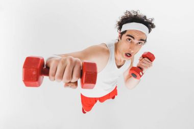 High angle view of young thin sportsman fist with dumbbell isolated on white clipart