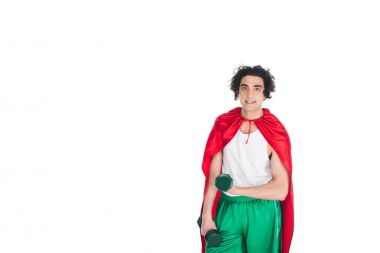 Young skinny sportsman with dumbbells standing in red cape isolated on white clipart