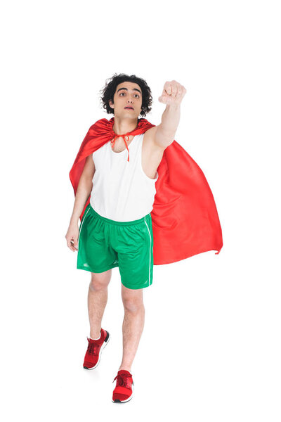 Young superhero in red cape depicting flying isolated on white