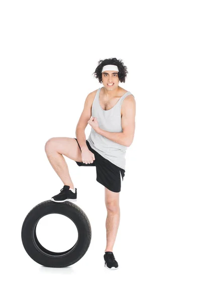 Thin Sportsman Holding Leg Tire Isolated White — Free Stock Photo