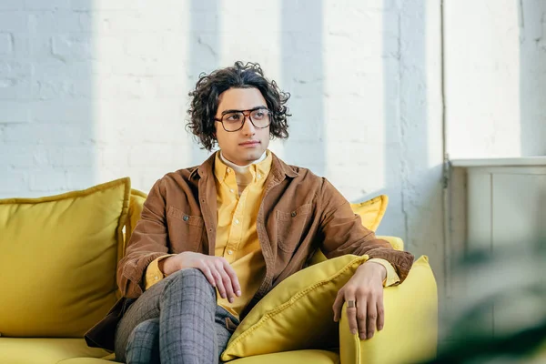 Young Stylish Man Eyeglasses Sitting Couch — Free Stock Photo