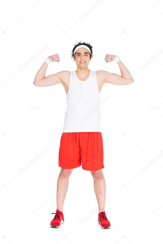 Young thin man in sportswear showing muscles isolated on white