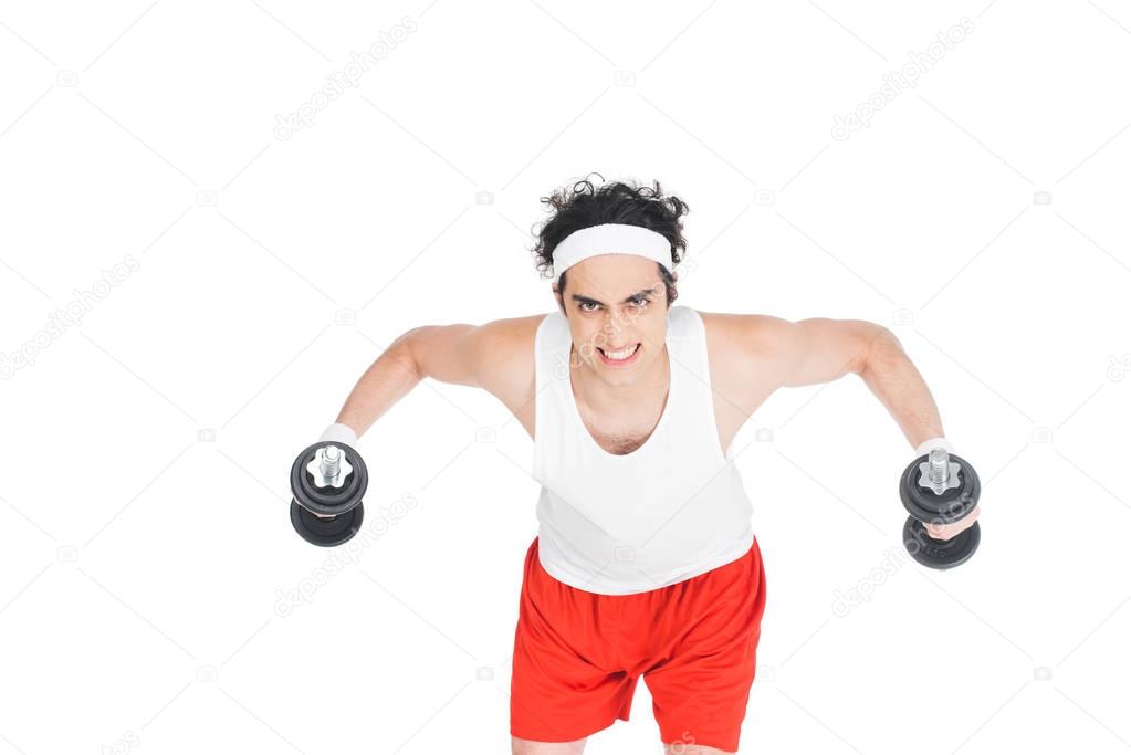 Portrait of young thin man in sportswear exercising with dumbbells isolated on white