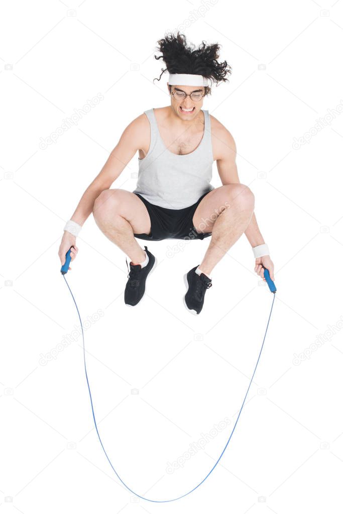 Skinny sportsman doing jump rope workout isolated on white