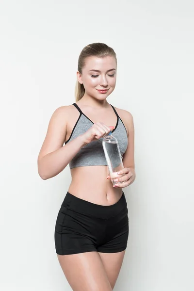 Fit Girl Opening Water Bottle Isolated White — Free Stock Photo