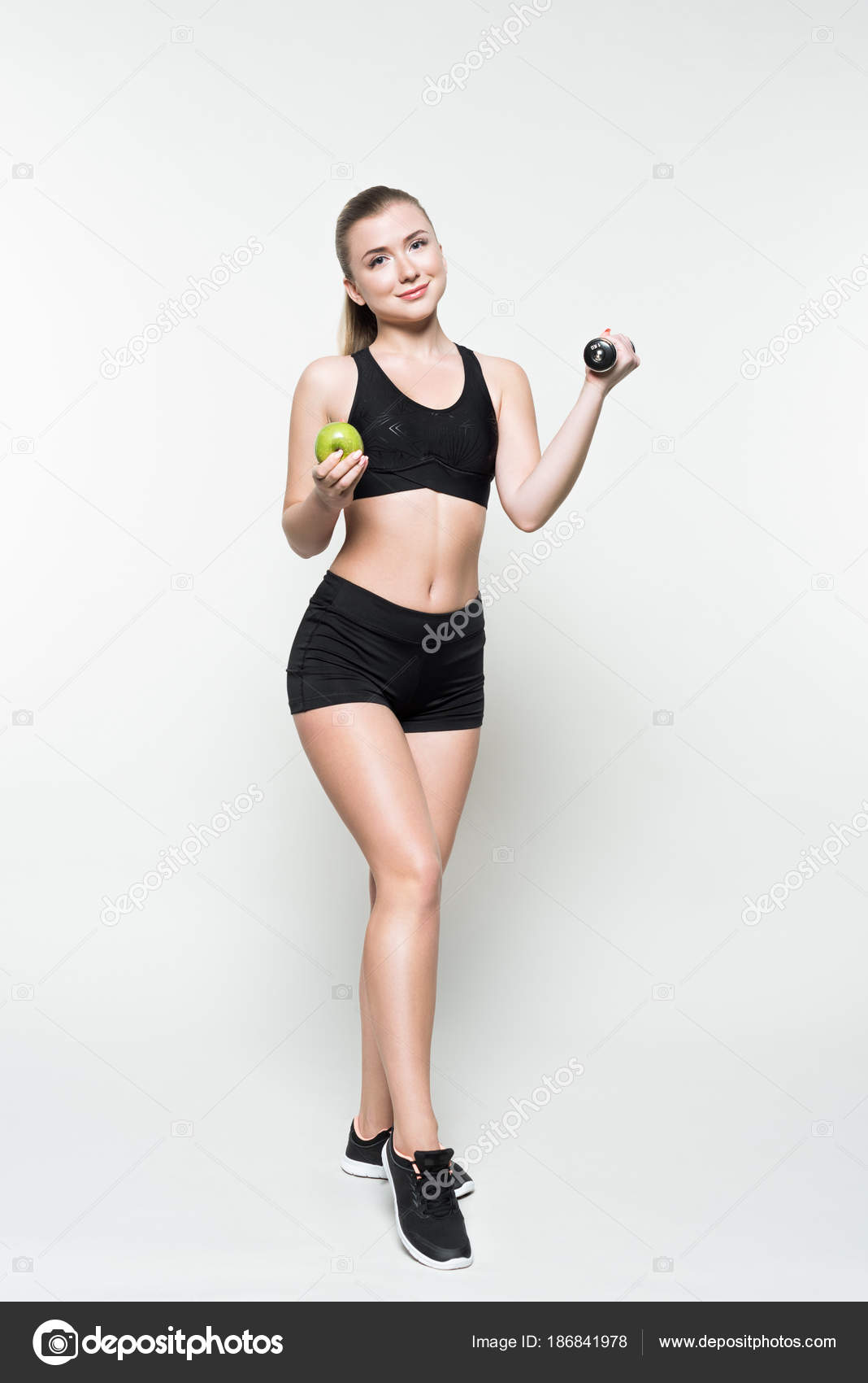 Blonde Woman Sport Clothes Holding Apple Dumbbell Isolated
